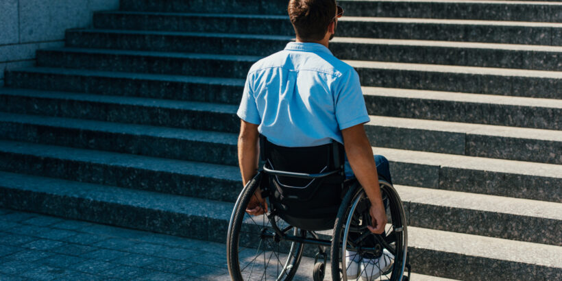 Back,View,Of,Man,Using,Wheelchair,On,Street,And,Looking Back,View,Of,Man,Using,Wheelchair,On,Street,And,Looking